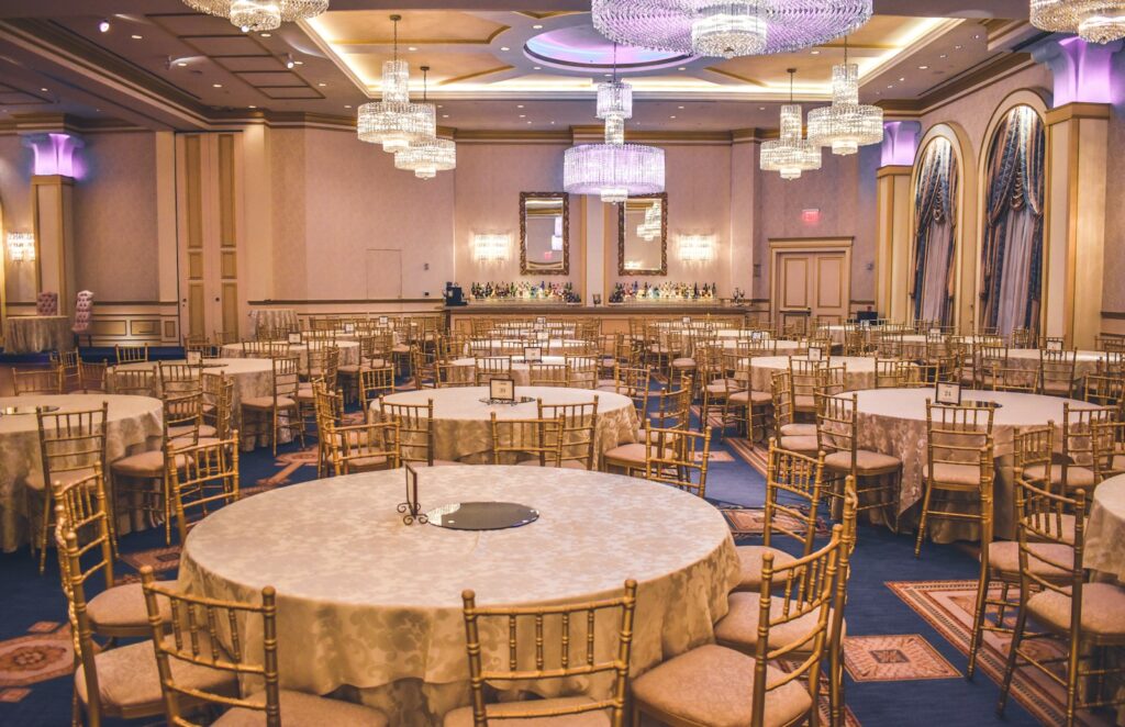 Elegant candlelit event tables set for a reception in a historic venue